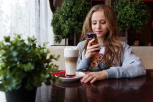 teenage student looking at phone