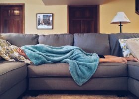 college student lying on couch